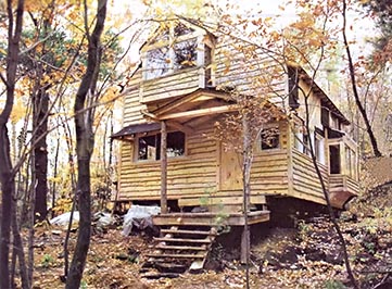 David and Herb's mostly finished country cabin. Slab-sawed siding—boards sliced from whole, unsquared saw logs with the bark left on the edges—give it a distinctive look.